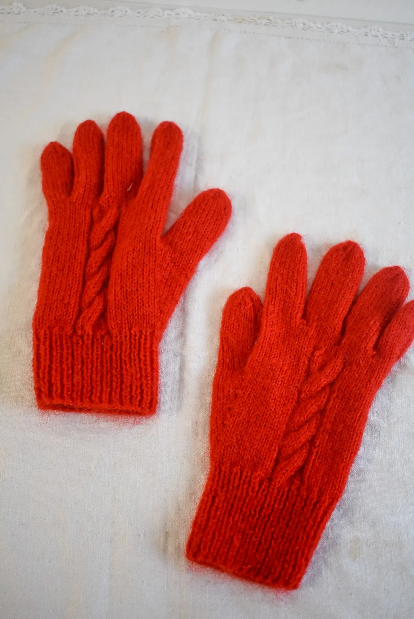 Bright red handknit gloves