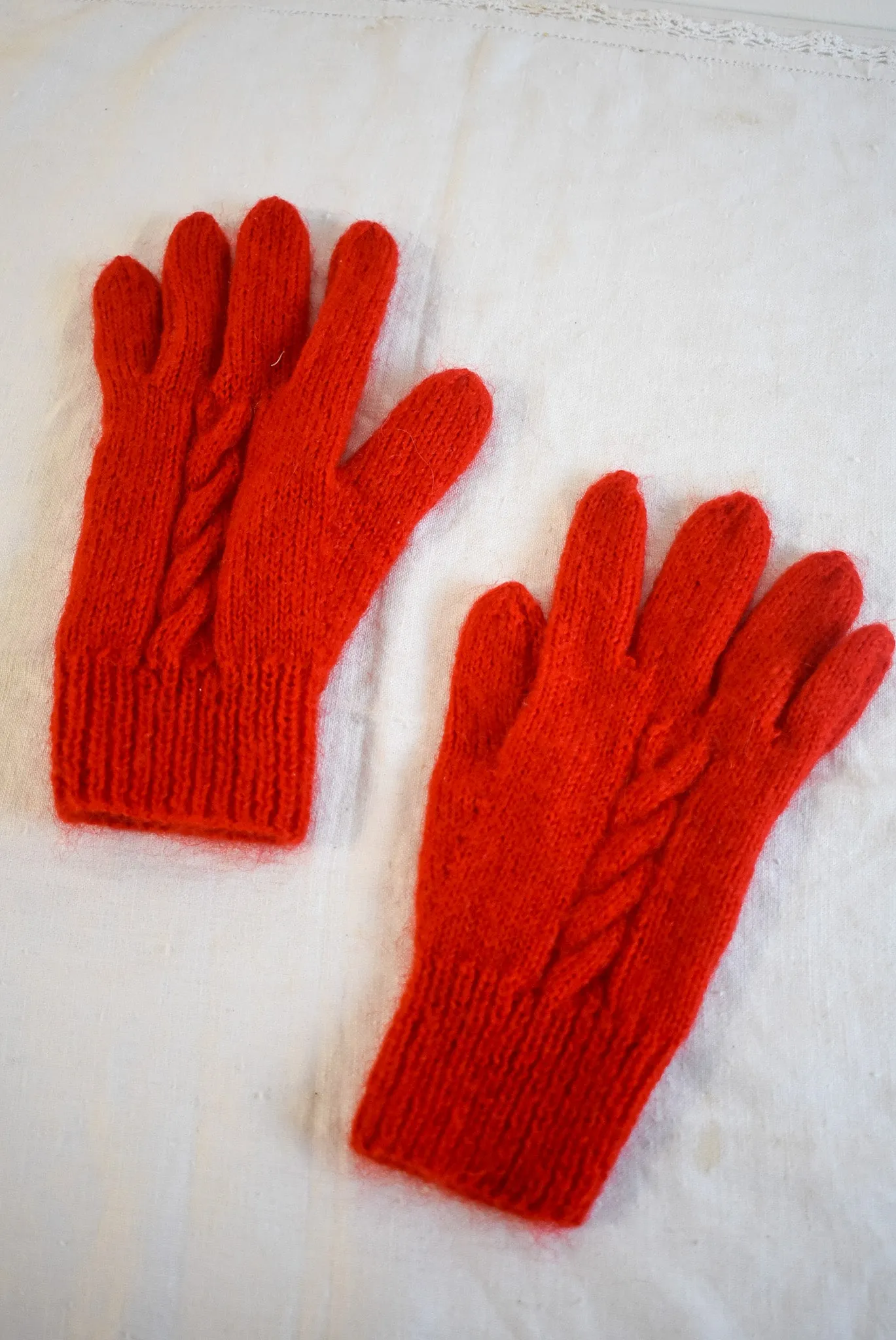 Bright red handknit gloves