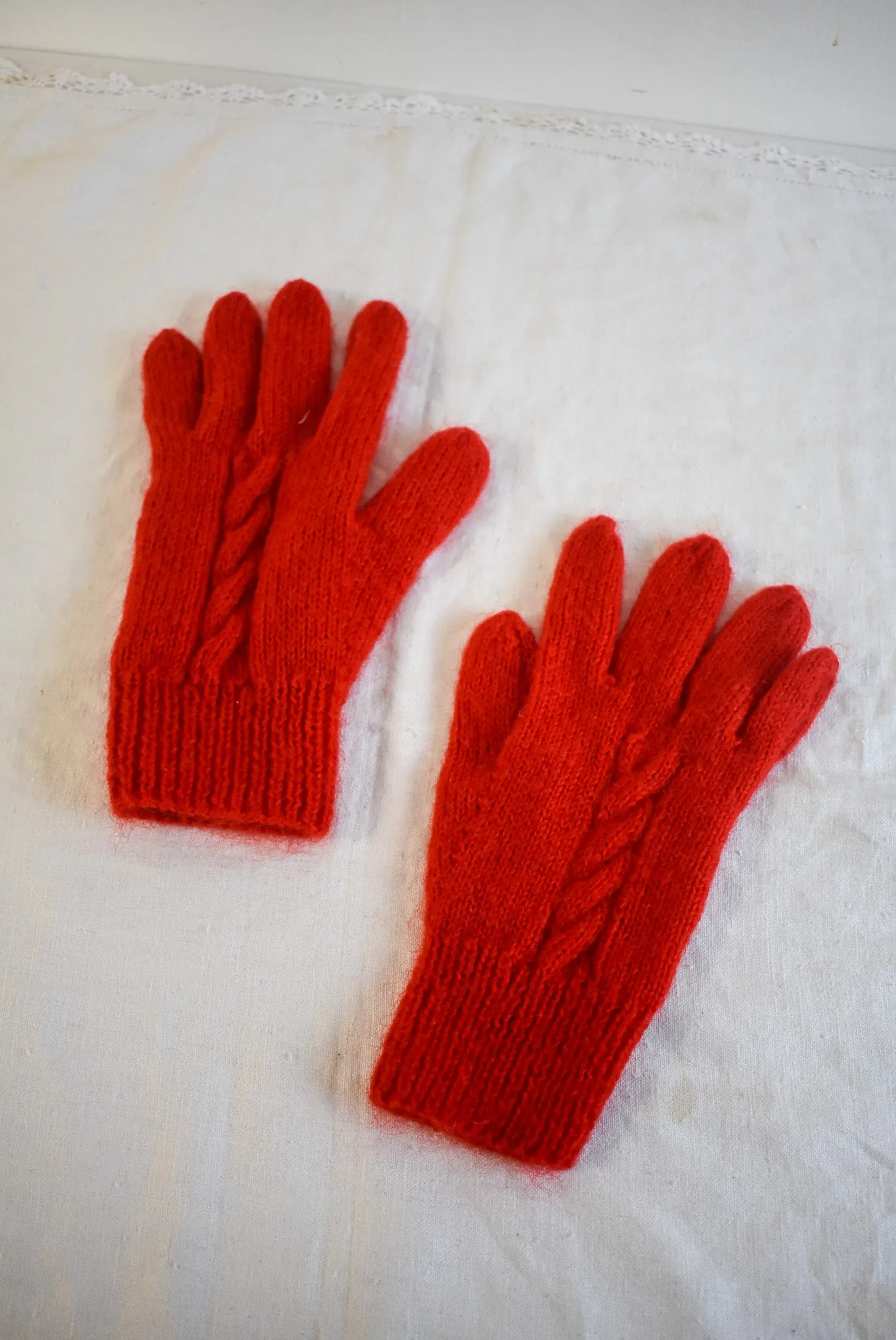 Bright red handknit gloves