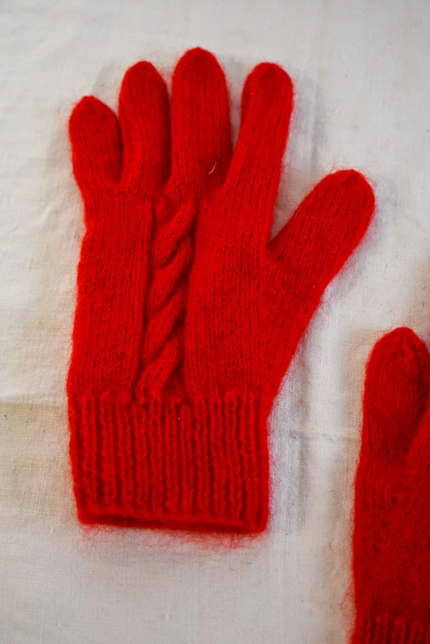 Bright red handknit gloves